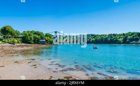 View of Menai Suspension Bridge over Menai Strait between the island of Anglesey and mainland Wales Stock Photo