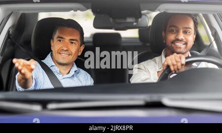 car driving school instructor teaching male driver Stock Photo