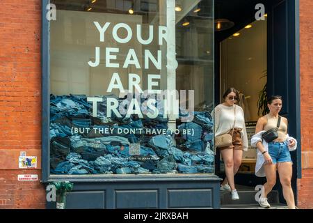 The window of a Madewell store in Soho in New York on Sunday, august 21, 2022 promotes the brand’s efforts to collect old used jeans and recycle them. Madewell collects old denim to be recycled turning them into environmentally friendly insulation and a offering a $20 credit off a new pair of jeans. Madewell is a brand of J.Crew. © Richard B. Levine) Stock Photo