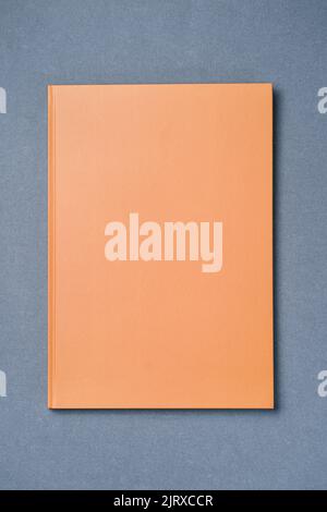 Orange Leather notebook on paper gray background, notepad mock up, top view shot Stock Photo