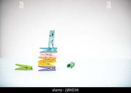 multi-colored clothespins for laundry on a white background Stock Photo