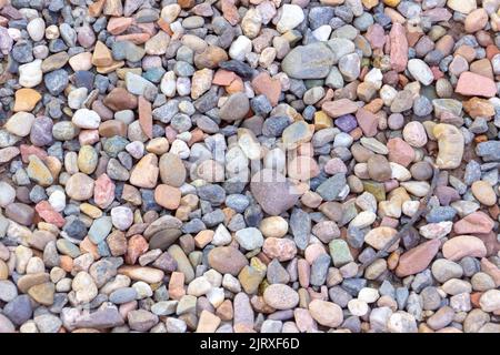texture of colored stones with a piece of twig in Rio de Janeiro Brazil. Stock Photo