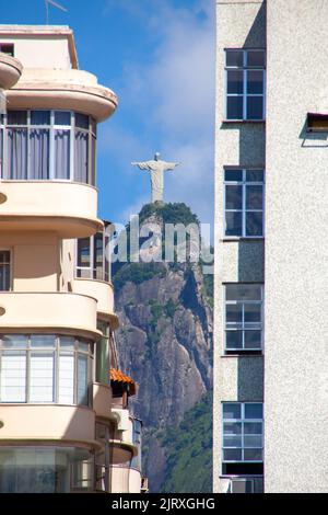 Christ the Redeemer in Rio de Janeiro, Brazil - March 31, 2019: Image of the statue of Christ the Redeemer among the buildings of the Botafogo cove in Stock Photo