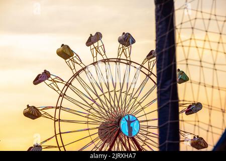 Toy giant park wheel Play City in Rio de Janeiro with a beautiful sunset background- January 12, 2019: Giant wheel of Playcity amusement park, with a Stock Photo