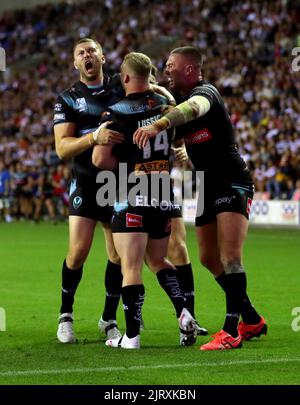 St Helens' Joey Lussick (centre) celebrates with his team-mates after scoring a try during the Betfred Super League match at the DW Stadium, Wigan. Picture date: Friday August 26, 2022. Stock Photo