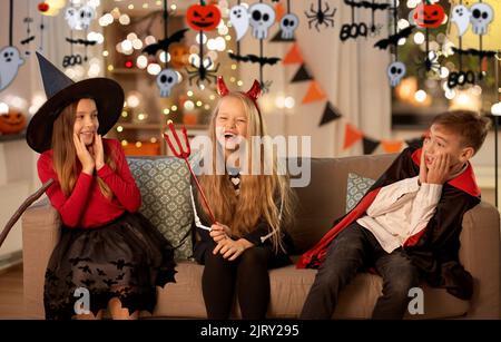 kids in halloween costumes playing at home Stock Photo