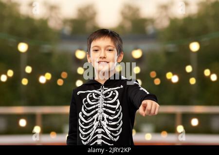 boy in halloween costume of skeleton at party Stock Photo