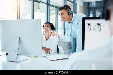 Manager, boss or worker helping new employee as call center agent, training a consultant at work and planning workflow with colleague at company Stock Photo
