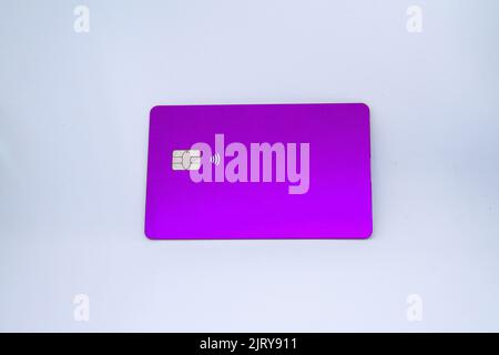 purple credit card with approach chip on a white background Stock Photo