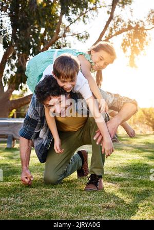 Never a dull moment when you have kids. Portrait of a happy father spending time with his son and daughter outdoors. Stock Photo