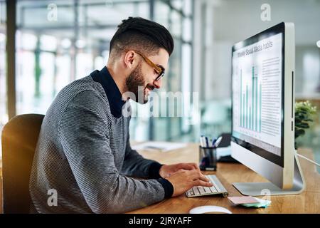 Working hard to double his success rate. a young designer working on a computer in an office. Stock Photo