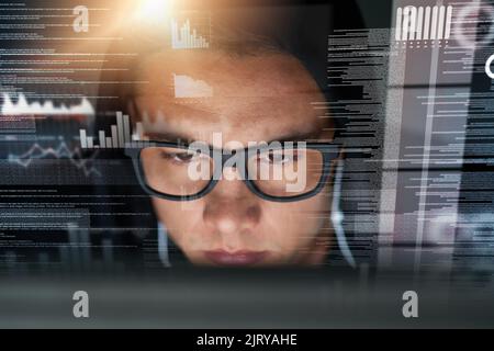 In the hacker zone. a hacker cracking a computer code in the dark. Stock Photo