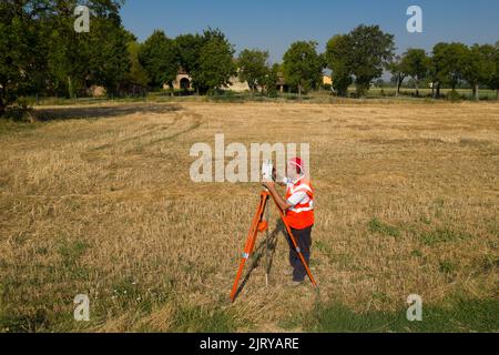 Land surveyor to measure land with  survey equipment camera tool Stock Photo