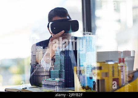 Build your own reality. Multiple exposure shot of a businessman wearing a VR headset while working in his office. Stock Photo