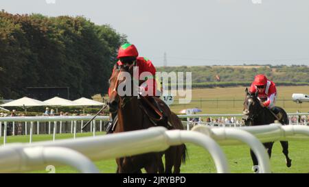 Newmarket, UK. 27th Aug 2022. Classic, ridden by Pat Dobbs wins the 2.35 Jenningsbet British EBF Novice Stakes ahead of Obelix, ridden by Robert Havlin (hidden) and Berkshire Phantom, ridden by William Buick,  (extreme right) at Newmarket Racecourse, UK. Credit: Paul Blake/Alamy Live News. Stock Photo