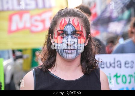 Buenos Aires, Argentina; August 25, 2022: young woman who has painted on her face the building of the national congress burning, protesting against fi Stock Photo