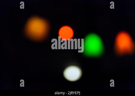 Abstract dark background with colourful twinkling lights in the evening, bokeh Stock Photo