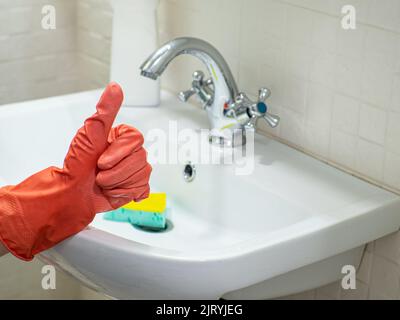 Person hand showing like bathroom sink and faucet Stock Photo