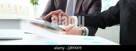 Two businessmen looking and studying analytics and business statistics Stock Photo