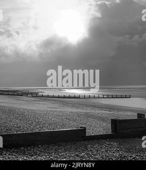 Black and White Stormy winters day on the beach at low tide Stock Photo