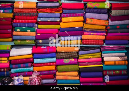 Artistic variety shade tone colors Saree's stacked on retail Shop Shelf to sale Stock Photo