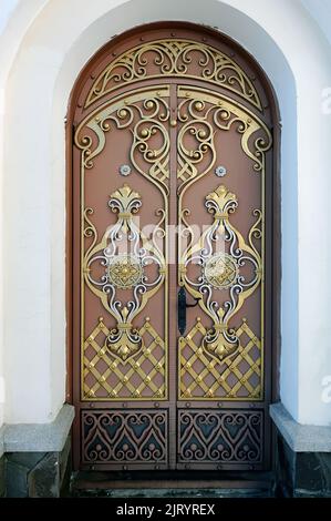 Ornate door with floral ornament in Pochayiv lavra in Ukraine Stock Photo