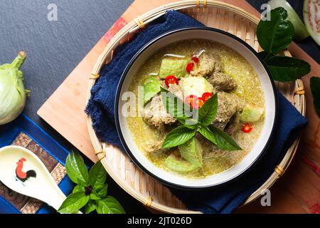 Asian Food concept Authentic Thai Green Curry beef and thai green eggplant on wooden board with copy space Stock Photo