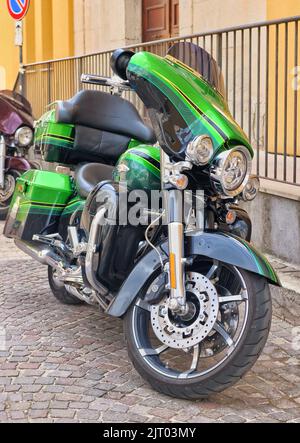 old retro motorcycle traveling through city streets Stock Photo