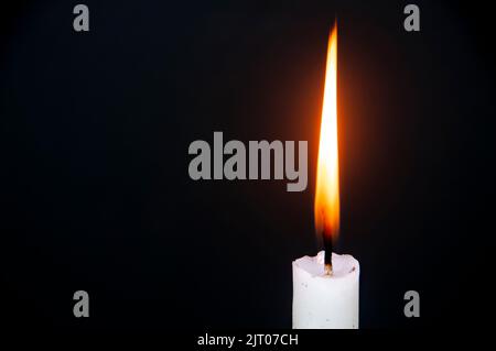 Candle light burning brightly with customizable space for text or ideas. Copy space with dark background. Stock Photo