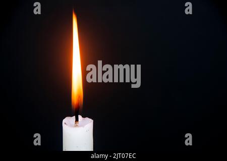 Candle light burning brightly with customizable space for text or ideas. Copy space. Stock Photo