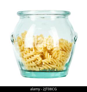 Raw pasta Fusilli in a glass jar isolated on white background. Raw and Dry Macaroni. Italian Culture. Top view. File contains clipping path. Stock Photo