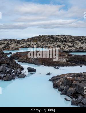 The milky blue waters from the geothermal power station that feed into the Blue Lagoon spa, Iceland. Stock Photo