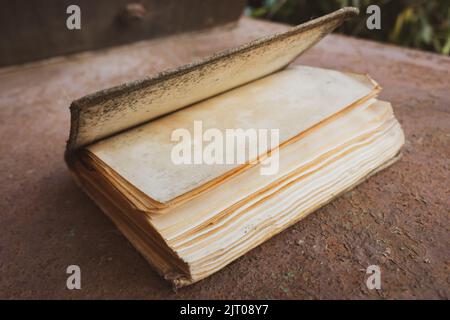 Old weathered book. Education concept. Aged book. Wisdom and knowledge concept. Vintage hardcover of book. School background. Retro literature. Stock Photo