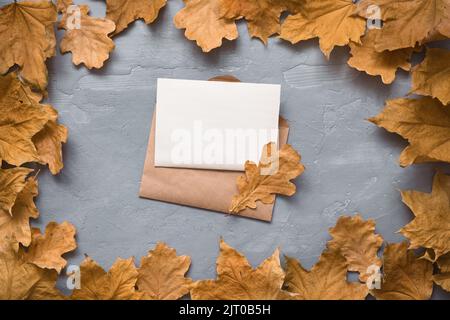 Autumn composition. Craft envelope. card mockup with autumn marple leaves. Flat lay, top view, copy space  Stock Photo