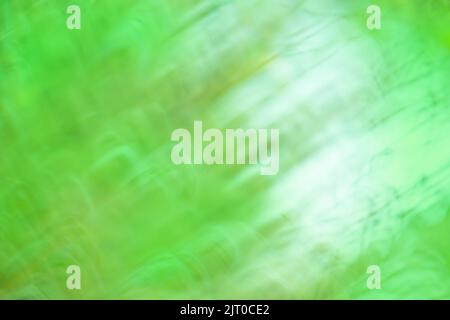 Natural outdoors  blurry effect bokeh in green. Fresh summer wallpaper concept illuminated with daylight. Stock Photo