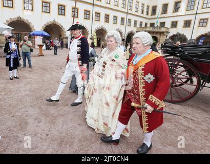 Gotha, Germany. 27th Aug, 2022. Performers in historical costumes walk in the courtyard of the residential palace at the 20th Gotha Baroque Festival. Friedenstein Palace will once again be transformed into the colorful residence of Duke Friedrich III of Saxony-Gotha-Altenburg (r. 1732-1772). Credit: Bodo Schackow/dpa/Alamy Live News Stock Photo