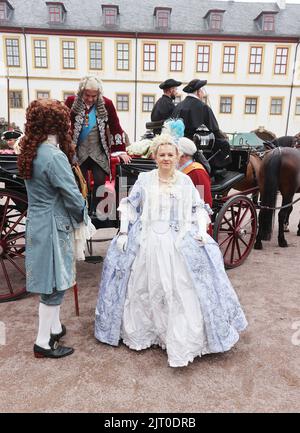 Gotha, Germany. 27th Aug, 2022. Performers in historical costumes stand in the courtyard of the residential palace at the 20th Gotha Baroque Festival. Friedenstein Palace will once again be transformed into the colorful residence of Duke Friedrich III of Saxony-Gotha-Altenburg (r. 1732-1772). Credit: Bodo Schackow/dpa/Alamy Live News Stock Photo