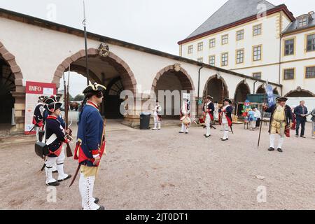 Gotha, Germany. 27th Aug, 2022. Performers of a court guard in historical costumes stand in the courtyard of the residential castle at the 20th Gotha Baroque Festival. Friedenstein Palace will once again be transformed into the colorful residence of Duke Friedrich III of Saxony-Gotha-Altenburg (r. 1732-1772). Credit: Bodo Schackow/dpa/Alamy Live News Stock Photo