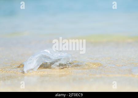 polyethylene bag on sand at beach , problem of pollution Stock Photo