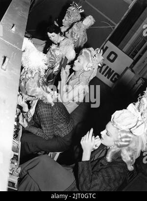 Female / Girl Extras doing their make-up on set candid during filming of MARIE ANTOINETTE 1938 director W.S. VAN DYKE art direction Cedric Gibbons gowns by Gilbert Adrian producer Hunt Stromberg Metro Goldwyn Mayer Stock Photo