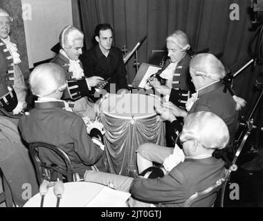 Male Musician Extras playing cards on an 18th Century Drum on the Versailles Ballroom Set during  a break in filming of MARIE ANTOINETTE 1938 director W.S. VAN DYKE art direction Cedric Gibbons gowns by Gilbert Adrian producer Hunt Stromberg Metro Goldwyn Mayer Stock Photo