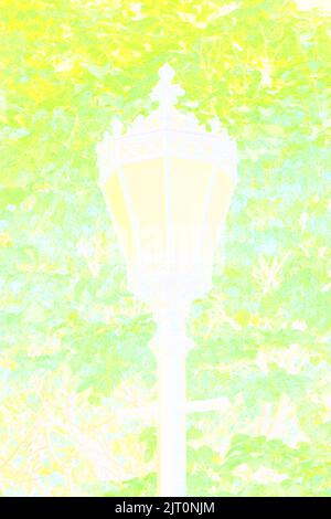 Single fancy and elaborate iron metal street lamp standing in the park in a bright abstract yellow view. Stock Photo