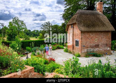 The traditional red brick thatched cottage in the Cottage Garden in the restored 'The Newt in Somerset' garden and hotel, nr Bruton, England, UK Stock Photo