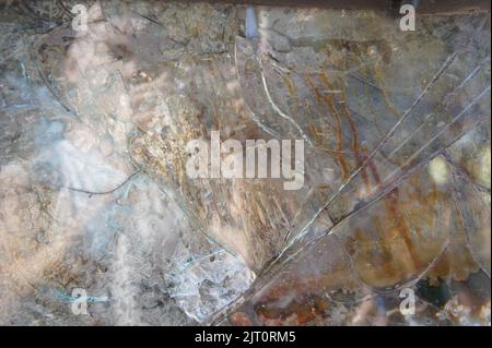 Armored glass after of a direct hit from an automatic weapon. Safety glass after being hit by a bullet. Bulletproof glass armored car after gunshot. T Stock Photo