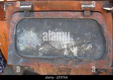 Armored glass after of a direct hit from an automatic weapon. Safety glass after being hit by a bullet. Bulletproof glass armored car after gunshot. T Stock Photo