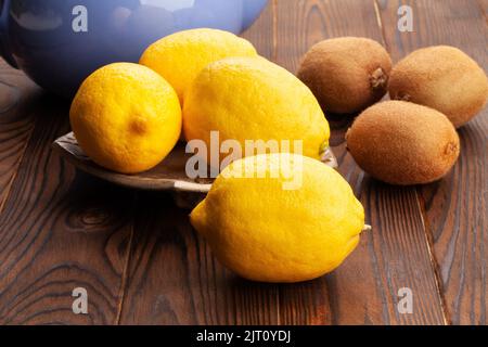 lemon on a plate on wood background Stock Photo