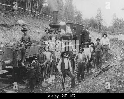 Building railroads. The group of workers on the railway construction between Angelsberg and Vansbro has come to a complete stop posing for the photographer. At this time year 1900 the work of digging way for the new railroad was mainly done by hand. Even children had jobs in the railway construction. Sweden 1900 Stock Photo