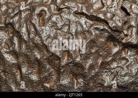 The metal meteorite surface close-up as background. Metal texture. Stock Photo