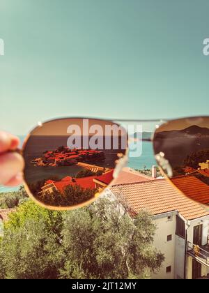 View of the island of Sveti Stefan through sunglasses Stock Photo