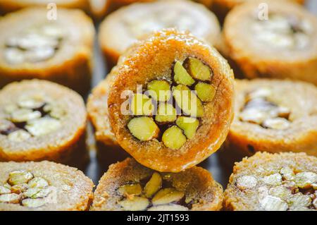 Arabic cuisine; Close up for Middle Eastern traditional pastries and Ramadan famous dessert 'Kunafa' with roasted pistachio. Stock Photo